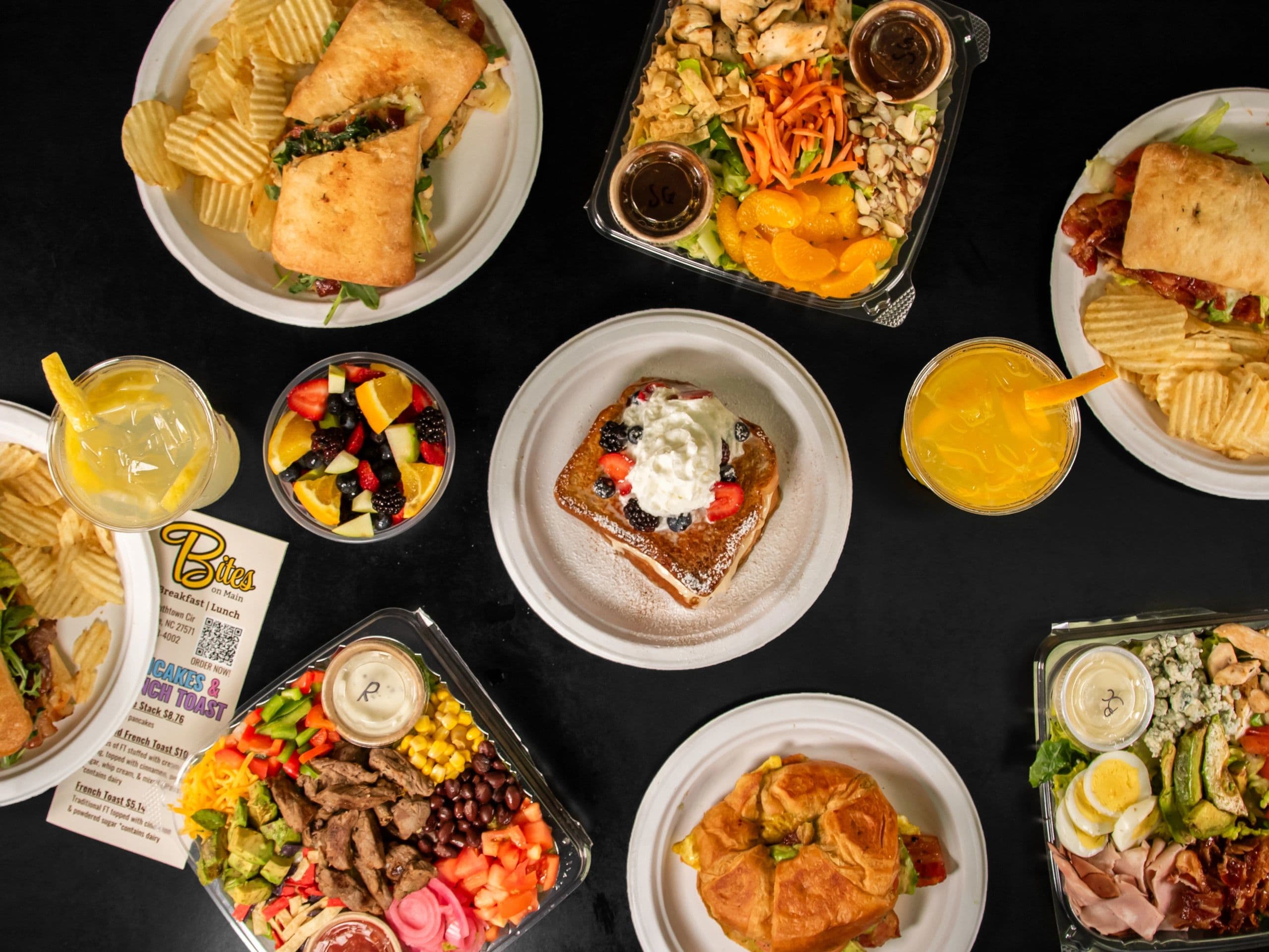 An overhead table of breakfast and lunch dishes from Bites on Main