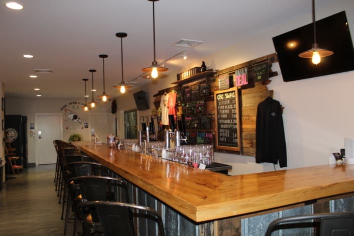 Wooden bar and beer taps in Carolina Brewing Company’s Holly Springs taproom