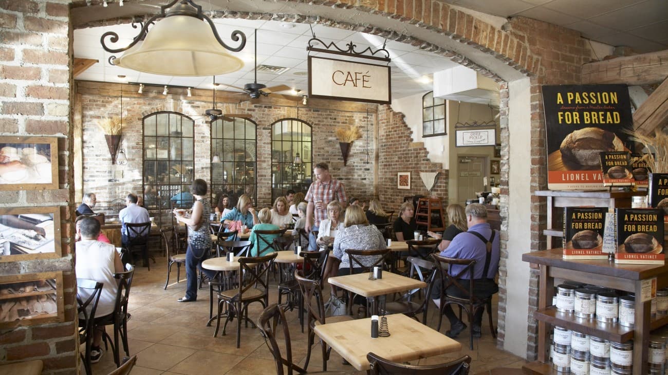 Tables beneath the archway inside La Farm Bakery’s café