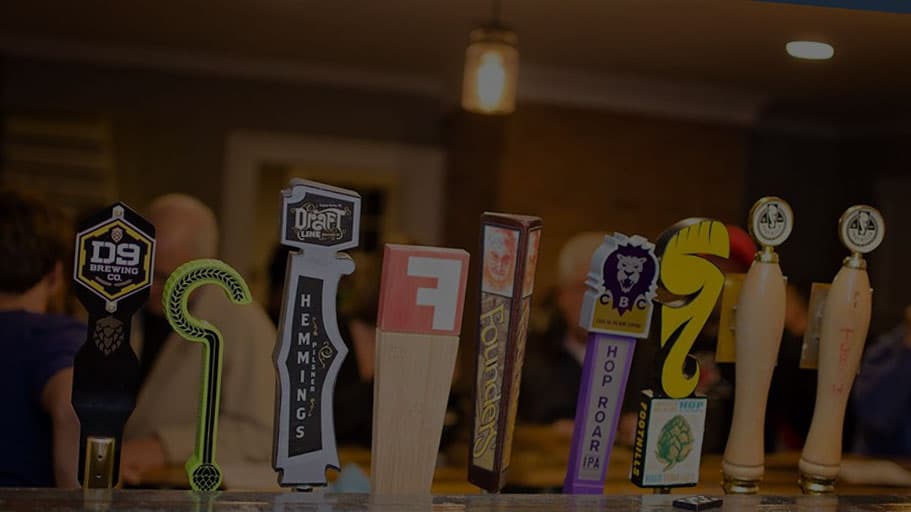 A row of beer tap handles inside Oak City Brewing Company