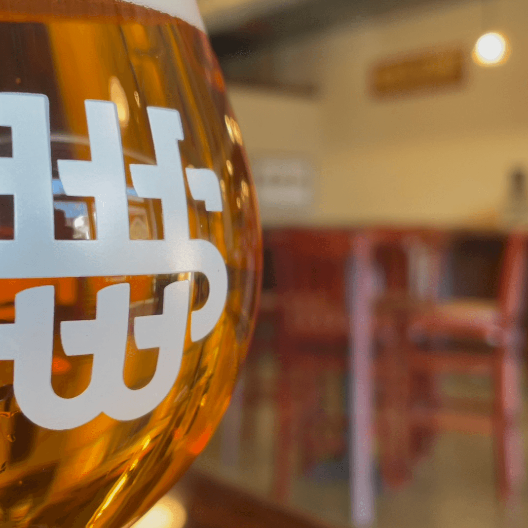 A White Street Brewing beer glass in the Wake Forest taproom’s photograph