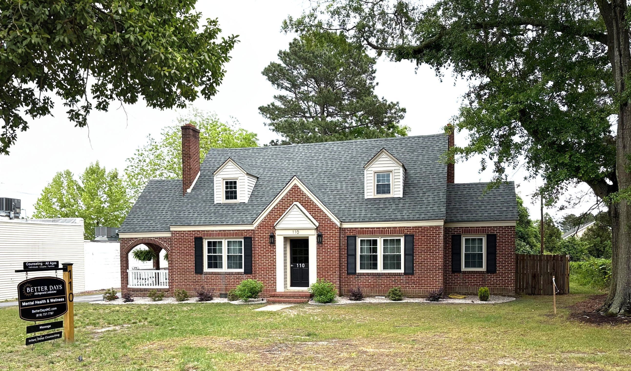 Brick house with a front lawn at Better Days’ Wendell office