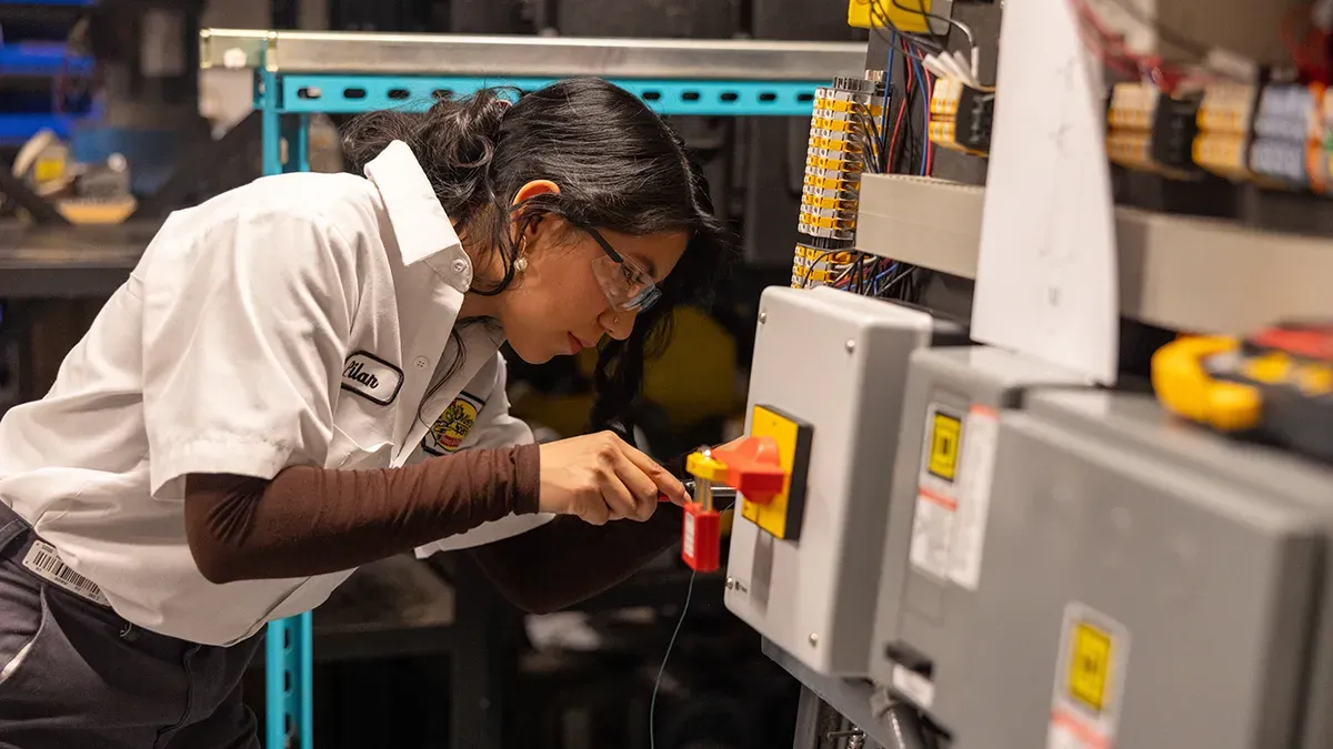 A Wake Tech student working with electrical training equipment