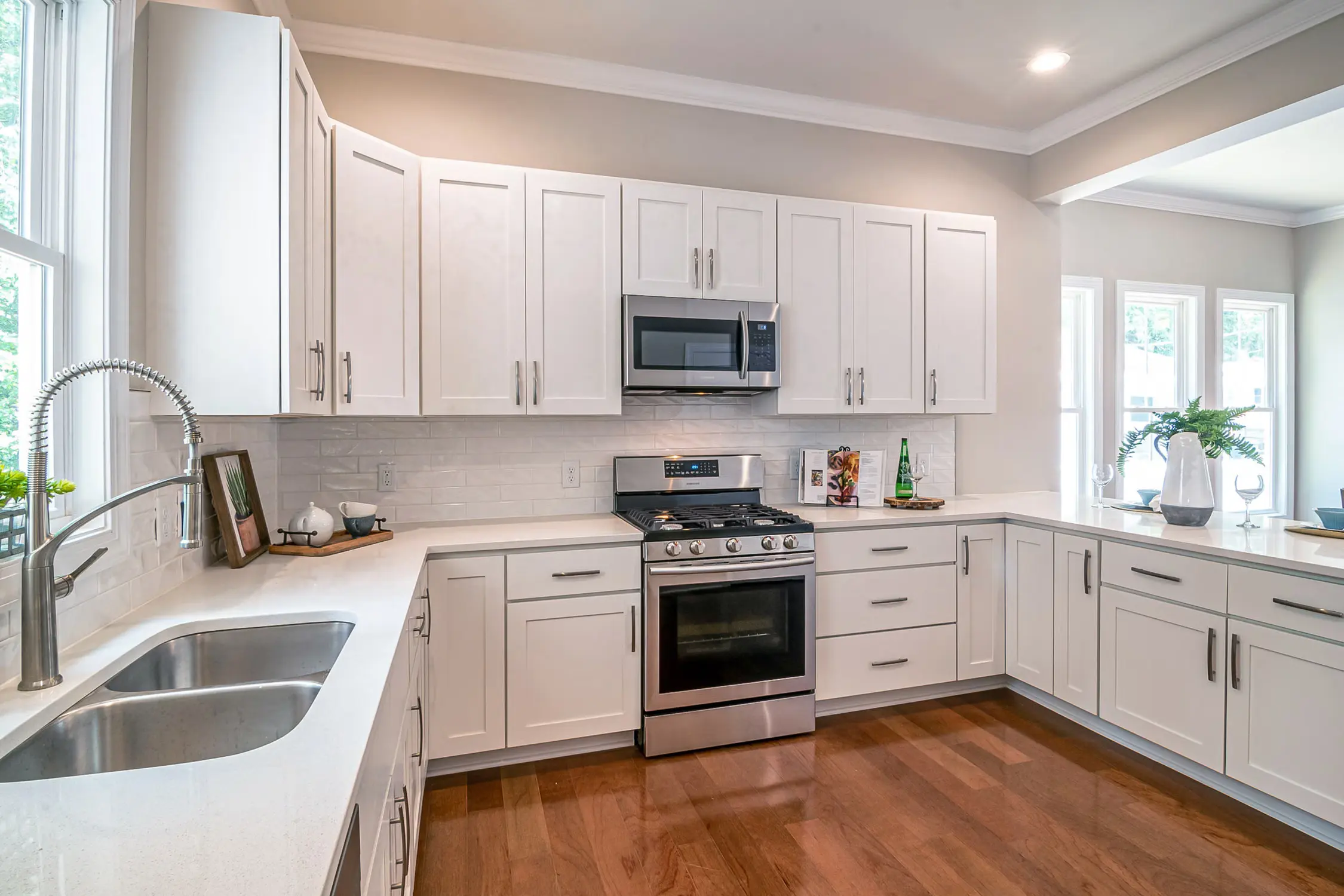 Bright white kitchen with wood floors and natural light